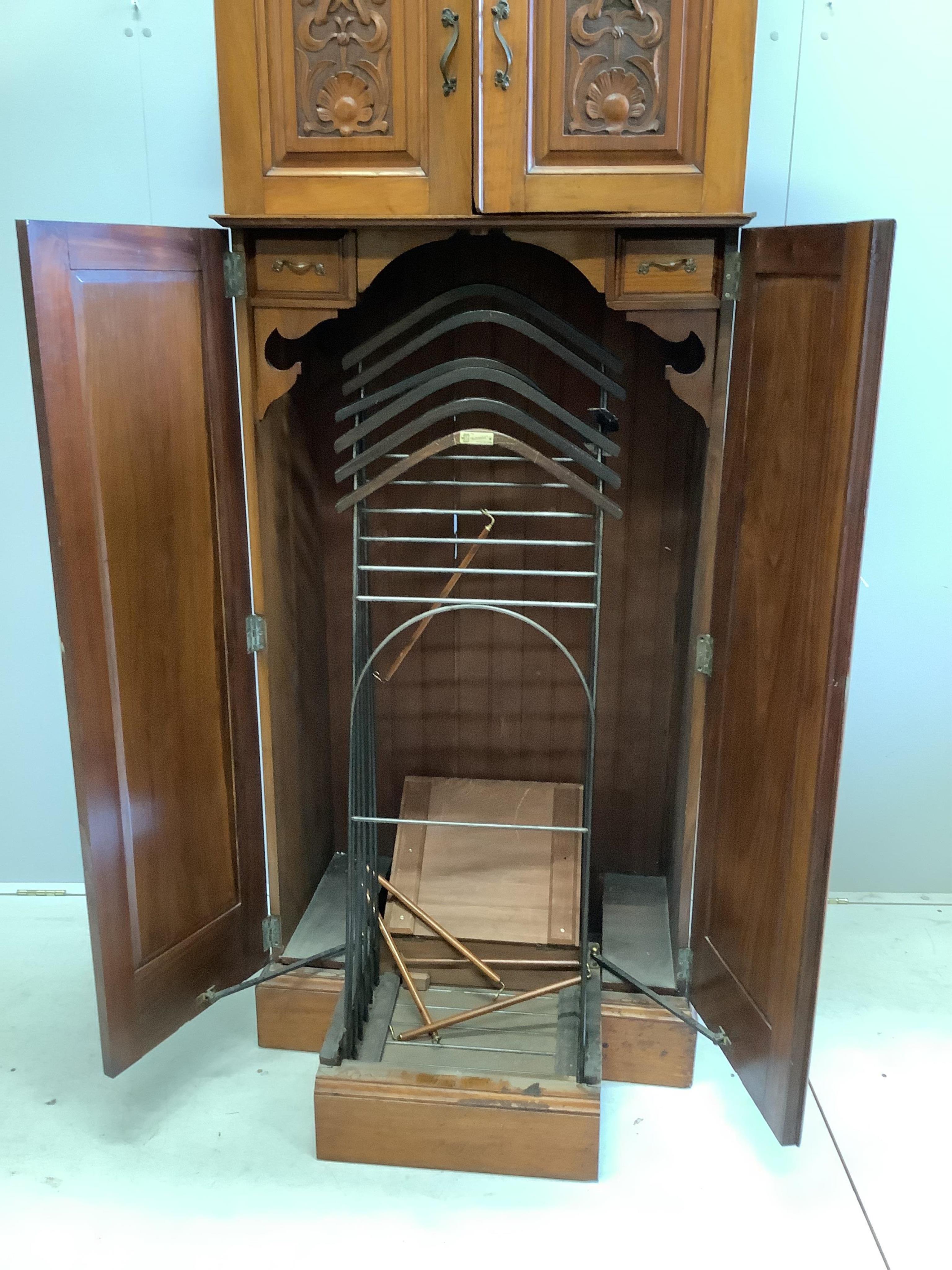 An Art Nouveau walnut gentleman's compactum wardrobe, width 77cm, depth 44cm, height 198cm. Condition - fair to good